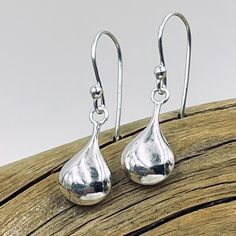 Delicate sterling silver puffed teardrop shines from sterling silver earring wires. Teardrop measures approximately 16mm x 8mm Classic Teardrop Drop With Polished Finish, Silver Teardrop Pearl Drop Earrings For Gift, Sterling Silver Teardrop Crown Earrings For Gift, Sterling Silver Long Drop Teardrop Earrings For Formal Occasions, Sterling Silver Drop Earrings For Everyday, Hypoallergenic Sterling Silver Teardrop Earrings For Formal Occasions, Hypoallergenic Sterling Silver Teardrop Earrings For Formal, Everyday Sterling Silver Drop Earrings, Hypoallergenic Teardrop Pendant For Everyday Wear