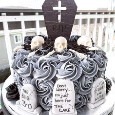 a decorated cake with skulls and tombstones on it