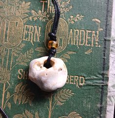 Hag Stone Pendant Pendulum Cord Necklace Witch Stone, Odin Stone This is a flint hag stone which has been eroded over time to give the hole in the centre.  Throughout many cultures these naturally eroded stones have been held as magical stones. Length of the cord and stone is 45cm long and has a slip know fastening. The stone measures approx 3.5cm x 3cm approx The cord is made from cotton and can be adjusted by the slip knot. Can be used as a pendulum also. The bead is a glass bead. Blessings fr Spiritual Necklace With Adjustable Cord, Adjustable Hand Cast Round Pendant Necklaces, Spiritual Pendant Jewelry With Adjustable Cord, Adjustable Pendant Necklace With Raw Stone, Spiritual Pendant Necklace With Adjustable Cord, Adjustable Bohemian Necklaces For Collectors, Hand Cast Bohemian Necklace As Gift, Adjustable Amulet Necklace For Meditation, Amulet Necklace With Adjustable Cord For Gifts