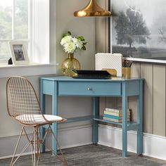 a blue desk with a chair next to it