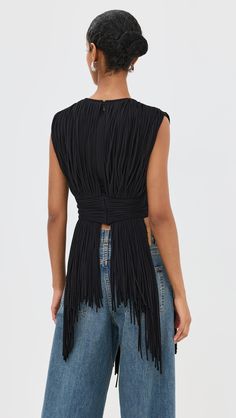 Find AREA Sleeveless Fringe Top on Editorialist. Fabric: Heavyweight, super-stretch jersey. Cascading fringe. Crew neck. Sleeveless. Hidden zip at back. Tie self-belt. Shell: 95% cotton/5% elastane. Hand wash. Imported, China. Measurements: Measurements from size XS Length: 16.5in / 42.0cm, from shoulder to shortest point Length: 32.25in / 82.0cm, from shoulder to longest point Fitted Sleeveless Fringe Tank Top, Fitted Sleeveless Tank Top With Fringe, Sleeveless Fringe Tops For Night Out, Fitted Fringe Tops For Evening, Black Fringe Top, Bohemian Jewels, Fringe Top, Fabric Weights, Hand Wash