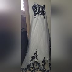 a white dress with black flowers on it