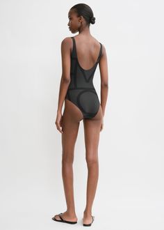 This swimsuit is printed with TOTEME's signature monogram pattern in two shades of black. It is made in Portugal from four way-stretch, recycled-polyamide jersey which protects against sun rays, and is shaped to a classic silhouette with a deep U-back. Pack it with the Monogram jacquard beach towel for your next vacation. Compressive Black Nylon Bodysuit, Black Compressive Nylon Bodysuit, Modern Black Stretch Bodysuit, Black Compressive Swimwear With Lined Body, Compressive Black Lined Swimwear, Black Second-skin Bodysuit For Poolside, Black Compressive Lined Swimwear, Black Swimsuit Bodysuit Second-skin Fit, Black Minimal Stretch Bodysuit For Swimming