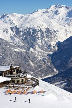 people are skiing on the snow covered mountains