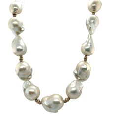 This impressive necklace features 19 large white baroque freshwater nucleated pearls ranging in size from 14 to 16mm! They have beautiful white and silvery-white pearlescence and have been hand strung on silk thread with 14k white and yellow gold spacers. A single 9.50mm round, white freshwater pearl accents each end, and the necklace has been finished with a beautiful white gold clasp. A contemporary look that will complement both your casual and dressy wardrobe, you can't go wrong with pearls! Luxury Vintage White Beaded Necklaces, Luxury White Baroque Pearl Necklace, White High Luster Round Beaded Necklaces, White High Luster Round Beads Necklace, White High Luster Round Bead Necklaces, Luxury White Baroque Pearl Necklaces, Baroque Pearl Briolette Necklace In Pearl White, Classic Baroque Pearl Necklace With High Luster, Luxury White Necklace With Polished Beads