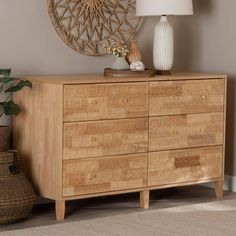 a wooden dresser sitting next to a lamp on top of a rug in a room