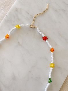 "This hand beaded flower necklace features rainbow or pastel flowers and measures 16\" at its smallest. Necklace is adjustable up to 18\" I love this necklace layered with other gold chains or worn alone to spruce up jeans and a t-shirt. Strung on elastic jewelry string and has a gold plated lobster clasp closure. Message me with any questions!" Adjustable Multicolor Beaded Necklace With Flower Pendant, Multicolor Adjustable Beaded Necklaces With Flower Pendant, Trendy Adjustable Flower Necklace With Colorful Beads, Multicolor Adjustable Beaded Necklace With Flower Pendant, Adjustable Flower Necklace With Round Beads For Spring, Trendy Adjustable Beaded Flower Necklace, Adjustable Rainbow Jewelry For Spring, Adjustable Beaded Necklace With Colorful Flower Pendant, Adjustable Beaded Necklace With Colorful Beads And Flower Pendant