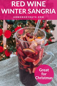 red wine sangria in a glass with strawberries and cranberries on the side