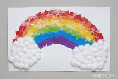 a rainbow made out of gummy bears on top of a white sheet of paper