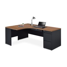 an office desk with a laptop on it