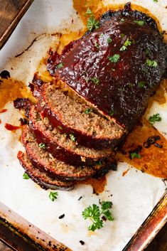 sliced meatloaf with sauce and parsley on top