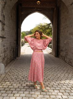 Perfect for dressing up or dressing down, our pink, paisley-patterned Karlou blouse is the ultimate summer wardrobe staple. Featuring a crewneck, a drawstring to tie on back, and 7/8th length balloon sleeves, this blouse is slightly cropped and totally adorable. Our model is also wearing the Larou skirt and Maddie jeans One size (fits from US 2-4-6-8) Length 18.5 in - Width 13.78 in 100% viscose Washing: handwash only Spring Crop Top Blouse With Blouson Sleeves, Pink Blouse With Gathered Lantern Sleeves, Pink Blouse With Lantern Sleeves And Gathered Details, Spring Cropped Blouse With Elastic Sleeves, Feminine Pink Blouse With Blouson Sleeves, Summer Viscose Blouse With Gathered Sleeves, Summer Blouse With Gathered Sleeves, Summer Blouse With Gathered Sleeves In Viscose, Pink Long Sleeve Viscose Blouse