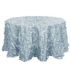 a round table covered in white ruffled fabric