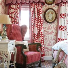 a bedroom decorated in pink and white with red accents