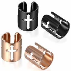 three different types of cuff rings with crosses on them, one in black and one in rose gold