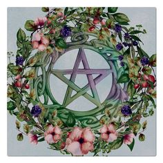 a pentagram surrounded by flowers and leaves