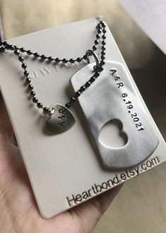 a person holding a necklace with a heart shaped key on it and a tag that says, i love you