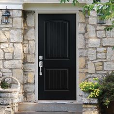 a black front door on a stone house