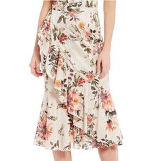 From Antonio Melani, This Skirt Features: Pencil Silhouette Ruffle Hemline Wrap Side Ruffle Floral Motif Invisible Zip; Hook/Eye Center Back Approx: 30.75" Length Cotton Polyester/Elastane Lining Dry Clean Imported. Chic Skirted Bottoms With Floral Print, Elegant Skirted Bottoms With Ruffle Hem, Feminine Asymmetrical Floral Print Skirt, Chic Floral Print Tiered Skirt, Feminine Midi Length Skirt For Garden Party, Elegant Spring Skirt With Ruffles, Elegant Spring Ruffled Skirt, Elegant Ruffled Skirt For Spring, Elegant Floral Print Bottoms For Brunch