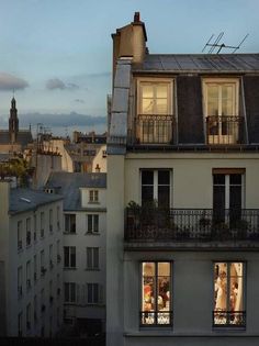 an apartment building with two balconies at dusk