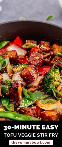 a pan filled with stir fry vegetables on top of a table