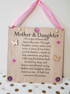 a mother and daughter poem hanging on a wall