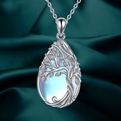 The Tree of Life Necklace is a powerful symbol representing positive energy, growth, strength, rebirth, longevity, good health, and new beginnings. This unique necklace features a tree of life pendant inlaid with moonstone, giving it a mysterious, elegant, and charming quality. Made of high-quality 925 sterling silver, this necklace is hypoallergenic, tarnish-resistant, nickel-free, lead-free, and cadmium-free, making it suitable for long-term wear, especially for those with sensitive skin. The teardrop pendant measures 0.54 by 1.13 inches and comes with an 18-inch chain with a 2-inch extension. It is elegantly packaged in a gift box, making it a perfect choice for birthday, congratulatory, or anniversary gifts for women, men, best friends, wives, lovers, grandmas, mothers, and more. Doctor Jewelry, Urn Bracelet, Celtic Knot Pendant, Urn Necklaces, Tree Of Life Necklace, The Tree Of Life, Tree Of Life Pendant, Unique Necklace, Teardrop Necklace