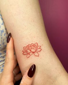 a woman's arm with a flower tattoo on the left side of her body