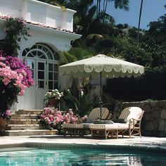 a pool with chairs and an umbrella next to it