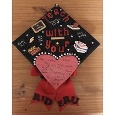 a graduation cap with writing on it and a red ribbon attached to the back that says, teen with your heart