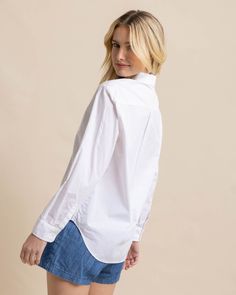 Crisp, clean, and classic, our essential white button-down is fresh and versatile. The button cuffs can be styled longer or shorter, and the button-tail hem provides different looks when tucked in or left out. This 100% cotton top is comfortable from the desk to the dock. Style: 10872 White Poplin Button-up Shirt, Classic Poplin Tops With Button Cuffs, White Poplin Tops With Button Cuffs, Everyday White Cotton Dress Shirt, White Cotton Dress Shirt For Everyday, Solid Shirt With Button Cuffs For Everyday Wear, White Relaxed Fit Poplin Shirt, White Poplin Shirt For Spring, Classic Shirt With Shirttail Hem For Everyday