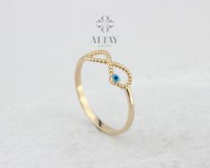 ABOUT PRODUCT  This 14k gold infinity evil eye ring is suitable gift for girlfriend, mom and her. You can even buy as a birthday gift for your friends or anniversary gifts, If you want to add a special note we can write for you and put to inside of package. We manufacture our jewelry pieces with carefully and after production we double checking in quality control department. Our main idea is keep our items for daily wearing especially for minimalist jewelry pieces. It's a perfect daily stacking Elegant Evil Eye Rings As Gift, Gold Infinity Ring, Luck Symbol, Protection Ring, Zierlicher Ring, Evil Eye Ring, Infinity Ring, Ring Minimalist, Eye Ring