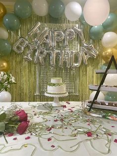 a birthday cake and balloons on a table