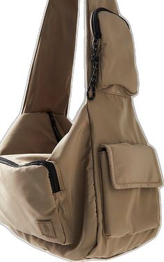 a beige bag with black zippers on the front and side pockets, attached to a white background