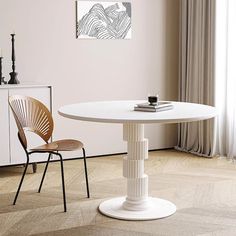 a white table and two chairs in a room