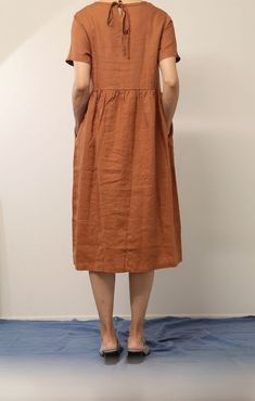 "This linen midi dress is a perfect example of beauty in simplicity. Made from breathable and soft linen, just right below the knee length, back tie at the neck line, this classic piece is such a no-brainer go to item. - Handmade with 100% medium weight linen - Short sleeves - Scoop neck - Back tie at the neckline - Below the knee length or customized length per request Please provide your shoulder width, full bust measurement ( measured around the fullest part ) and your height along with your A-line Sundress Maxi Dress With Pockets, Casual Plain Solid Linen Dress, Knee-length Plain Midi Dress For Spring, Spring Knee-length Plain Midi Dress, Plain Knee-length Midi Dress For Spring, Spring Plain Knee-length Midi Dress, Casual Solid Color Dresses With Pockets, Knee-length Solid Color Cotton Dress, Casual Solid Dresses With Pockets