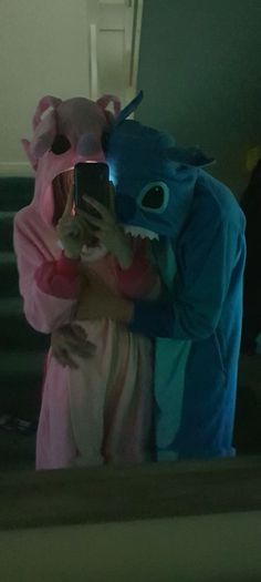 two people dressed in animal costumes taking a selfie