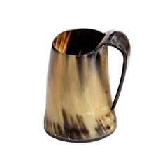 a brown and white pitcher with a black handle