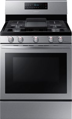 an oven with the door open and two burners on each side, in stainless steel