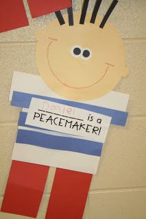 a paper cut out of a boy holding a sign that says danger is a peacemaker