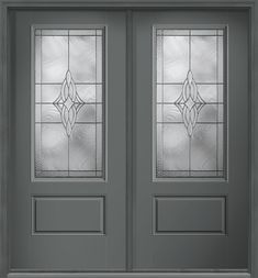 the front door is painted gray and has two glass panels on each side, with an intricate