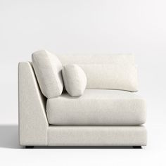 a white couch with two pillows on the back and one arm folded up to show it's shape