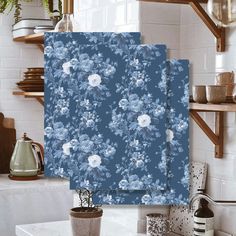 two pieces of blue and white wallpaper with flowers on them in a kitchen setting