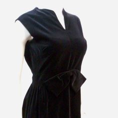 You Will Look Like You Just Stepped Off The Runway Wearing This Vintage 1950's Black Velvet Sleeveless Wiggle Pencil Style Cocktail Dress. Made In The Usa Of 100% Cotton Velvet, This Vintage Dress Has A Sexy V Neck, Attractive Gathering At The Waist Line And A Big Black Velvet Bow To Accent Your Figure In All The Right Ways. Label-Vickie Vaugh/ Made In Usa/Union Garment Workers Label/100% Cotton Velvet Condition-Good Vintage Condition Without Damage Or Fading. Some Photos Have Been Lightened To Retro Sheath Dress For Formal Occasions, Vintage Sleeveless Dress For Night Out, Retro Sleeveless Mini Dress For Evening, Vintage Sleeveless Mini Dress For Evening, Retro Black Cocktail Dress, Retro Sleeveless Dress For Evening, Retro Sleeveless Evening Dresses, Vintage V-neck Mini Dress For Formal Occasions, 1950s Style Sleeveless Cocktail Dress