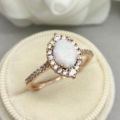 This beautiful ring is made from genuine 925 sterling silver with rose gold plating. Engagement Ring details- -The Main stone is an oval cut 8mm by 6mm Lab Created White Fire Opal Stone -Side stones are 1.2-2MM Round simulated diamonds -Ring is cast in solid 925 sterling silver with rose gold plating (yellow gold and rhodium plated also available, please check the drop down menu for more options) -The Total face height of the ring measures 10mms and the band width measures 1.4mms -Each ring is h 14k Rose Gold Oval Center Stone Jewelry, Classic 14k Rose Gold Halo Rings, Classic 14k Rose Gold Rings With Halo Design, 14k Rose Gold Halo Design Jewelry Gift, 14k Rose Gold Halo Promise Ring, Elegant Oval 14k Rose Gold Ring, Oval 14k Rose Gold Rings For Formal Occasions, Oval Rose Gold Diamond Ring With Gemstone, Oval Rose Gold Diamond Ring