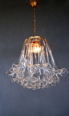 a glass chandelier hanging from a ceiling