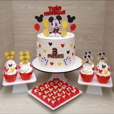 a mickey mouse birthday cake and cupcakes