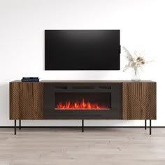 an entertainment center with a fireplace in the middle and a flat screen tv above it