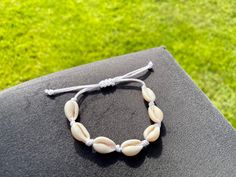 These cowrie shell bracelets and anklets look perfect for the beach! Your bracelet / anklet will come packed in a white mesh bag, complete stickers and freebies! They are fully adjustable to fit comfortably. Check out other jewellery in our shop too (bigger orders get more freebies!) We also take custom orders (through our shop page)! Beachy Friendship Bracelets For Summer, Casual Beaded Bracelets For Summer Beach, Casual Braided Bracelets For Beach In Summer, Summer Beachy Friendship Bracelets, Casual Braided Bracelets For Summer Beach, Summer Shell Strand Friendship Bracelets, Casual Beach Jewelry With Cowrie Shell, Summer Adjustable Shell Beaded Bracelets, Casual Friendship Bracelets For Summer Beach Party