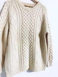 "Cream chunky knit, fisherman wool sweater with a crew neck design. This sweater is warm, definitely a fall and winter staple. Material: 100% pure wool Condition: In good vintage condition. Faint yellow stain on the right torso of the sweater. Measurements: Shoulder to shoulder: 21\" Bust: 24\" Length: 29\" Sleeve length: 23\" Estimated Size: Large Remember shipping is FREE to US IMPORTANT Pay close attention to measurements and pictures. Measurements are made with the item laying flat and are n